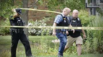 Police investigate a shooting on Friday, Aug. 5, 2022, in Butler Township, Ohio. Authorities say four people were shot to death in the Ohio suburb and a man considered armed and dangerous is being sought.