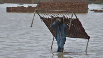 A man carries cot after he salvaged it from his flood-hit home in Jaffarabad, a district of Pakistan's southwestern Baluchistan province. 
