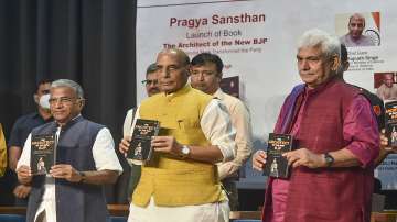 Defence Minister Rajnath Singh, J & K Governor Manoj Sinha and Deputy Chairman of the Rajya Sabha Harivansh Narayan Singh during launch of the book "The Architect of the New BJP: How Narendra Modi Transformed the Party", in New Delhi.