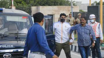 Shrikant Tyagi, accused of assaulting a woman, being brought to the Police Commissioners office after he was arrested by UP Police, in Noida, Tuesday, Aug. 9, 2022.