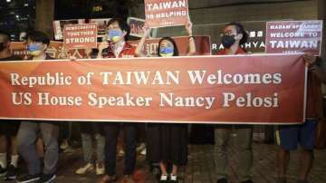 Supporters hold a banner outside the hotel where US House Speaker Nancy Pelosi is supposed to be staying in Taipei, Taiwan