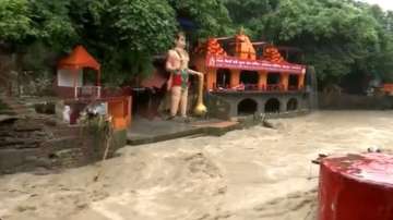 River Tamasa in spate near Tapkeshwar Mahadev temple in Dehradun following continuous rains in the area.