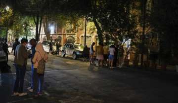 People gather outside after an earthquake was felt in Mexico City, Thursday, Sept. 22, 2022.