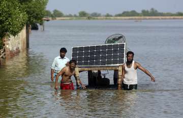 Victims of unprecedented flooding from monsoon rains use a cot to salvage belongings from their flooded home, in Jaffarabad, Pakistan, Monday, Sept. 5, 2022. 