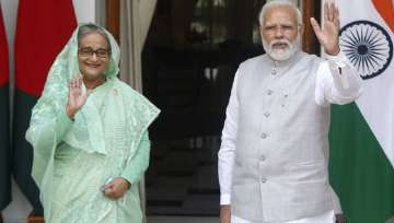 Indian Prime Minister Narendra Modi, right, and his Bangladeshi counterpart Sheikh Hasina wave to the waiting media before their delegation level talks in New Delhi, India, Tuesday, Sept. 6, 2022. 