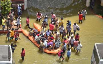 Bengaluru: Fire fighters evacuate residents from flooded Rainbow Drive Layout after heavy monsoon rains at Sarjapur