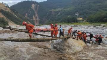 In this photo released by Xinhua News Agency, rescuers transfer survivors across a river following an earthquake in Moxi Town of Luding County, southwest China's Sichuan Province Monday, Sept. 5, 2022.