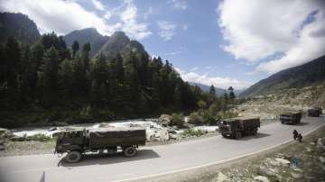 An Indian army convoy moves on the Srinagar- Ladakh highway at Gagangeer, northeast of Srinagar.