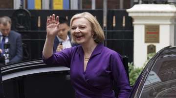 Liz Truss waves as she arrives at the Conservative Campaign Headquarters (CCHQ) following the announcement that she is the new Conservative party leader, and will become the next Prime Minister, in London.