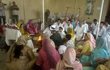 Family members of late BJP leader Sonali Phogat pray during a condolence meeting in Hisar district.