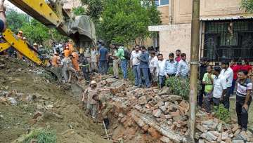 Noida: Rescue operation underway after a portion of a boundary wall of a housing society collapsed, at Jal Vayu Vihar in Noida, Tuesday, Sept. 20, 2022.