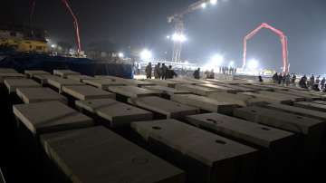 Stones slabs meant for the last phase of the foundation of the Ram Mandir are seen in the foreground at the site of the Ram Mandir construction, in Ayodhya.