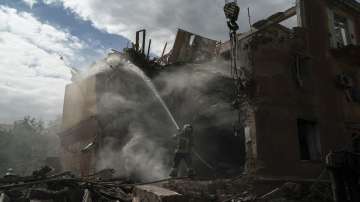 A firefighter works to extinguish a fire after a Russian attack that heavily damaged a residential building in Sloviansk, Ukraine.