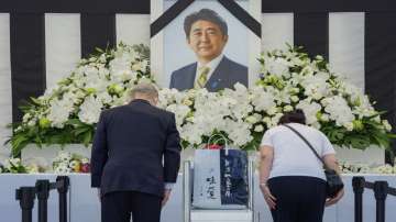 People leave flowers and pay their respects to former Japanese Prime Minister Shinzo Abe outside the Nippon Budokan in Tokyo Tuesday, Sept. 27, 2022, ahead of his state funeral.
