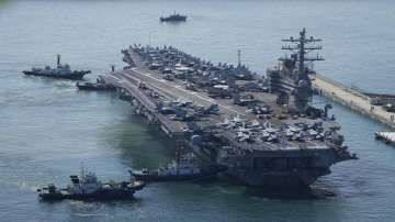 The US carrier USS Ronald Reagan is escorted as it arrives in Busan, South Korea, Friday, Sept. 23, 2022. 