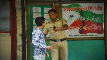 A security person keeps vigil outside the Popular Front of India (PFI) party office in Navi Mumbai.. 