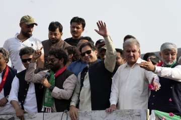 Pakistan's former Prime Minister Imran Khan, center, gestures to his supporters at a rally in Lahore. 