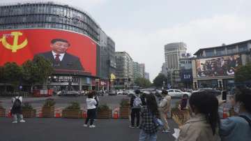 Chinese President Xi Jinping is seen at the end of the Chinese Communist Party's 20th Party Congress on a giant screen a commercial district of Hangzhou in eastern China's Zhejiang province. 