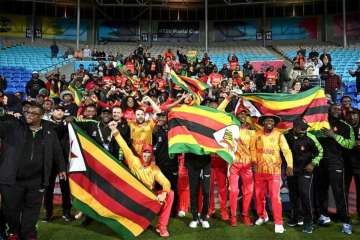 Team Zimbabwe celebrates their win vs Pakistan with the fans.