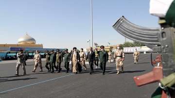 In this picture released by the official website of the office of the Iranian supreme leader, Supreme Leader Ayatollah Ali Khamenei, center, reviews a group of armed forces cadets during their graduation ceremony accompanied by commanders of the armed forces, at the police academy in Tehran, Iran.