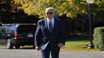 President Joe Biden walks to talk to reporters on the South Lawn of the White House.