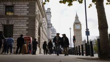 People walk with the Big Ben tower of Houses of Parliament in London. (Representational image)