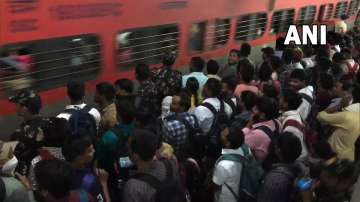 Candidates struggle to board train due to high rush at railway station.