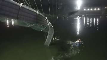 Rescuers on boats search in the Machchu river next to a cable bridge that collapsed in Morbi district in Gujarat.