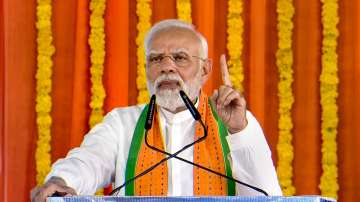 Prime Minister Narendra Modi addresses during the launch of development initiatives in Amod, Gujarat, on Monday.