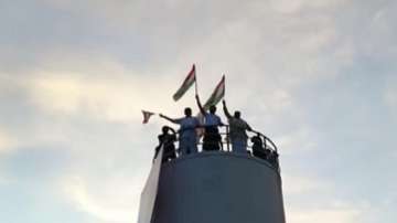 Rahul Gandhi climbs a water tank and waves the tricolour during Bharat Jodo Yatra