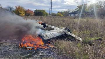 Fragments of a Russian rocket that was shot down by the Ukrainian air defence system burn down in the village of Kipti.