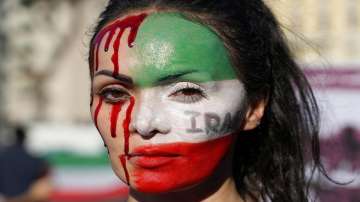 A woman is painted on a her face during a protest against the death of Mahsa Amini, a woman who died while in police custody in Iran.