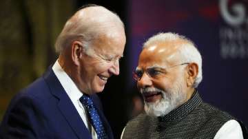 India's Prime Minister Narendra Modi talks with U.S. President Joe Biden as they arrive for the first working session of the G20 leaders summit in Nusa Dua, Bali, Indonesia. 
