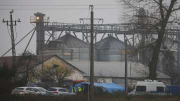 Police officers work outside a grain depot where, according to the Polish government, an explosion of a Russian-made missile killed two people in Przewodow, Poland on Wednesday.