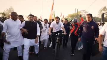Rahul Gandhi rides a bicycle during Bharat Jodo Yatra in MP's Ujjain.   