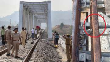 Police personnel investigate after an explosion on Udaipur-Ahmedabad railway track in Udaipur.