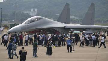 Visitors look at the J-16D electronic warfare variant of the Chinese military's J-16 airplane during 13th China International Aviation and Aerospace Exhibition