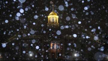 Snow falls during a blizzard warning, Wednesday, Dec. 21, 2022, at the Old Capitol Building in Iowa City, Iowa. 