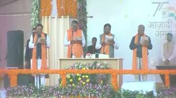 Gujarat BJP leaders hold Bhagavad Gita while taking oath of office.