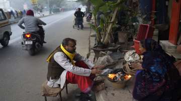 People warm themselves around a bonfire as temperatures plummet in New Delhi.