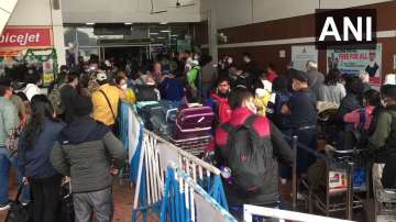 People wait for news about the cancelled flights. 