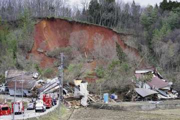 Rescuers gather at the site of a landslide in Tsuruoka, Yamagata prefecture, north of Tokyo Saturday, Dec 31, 2022.