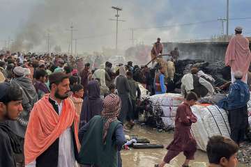 People were seen gathering beside a burnt truck after Afghan forces shelled Pakistani town Chaman, which is located on the country's southwestern border along Afghanistan. 