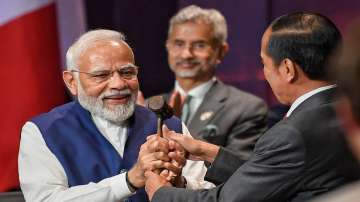 President of Indonesia Joko Widodo symbolically hands over the G20 Presidency to Prime Minister Narendra Modi at G20 summit, in Bali, Indonesia on Nov. 16