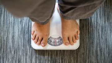 Representative image of a man standing on weight machine