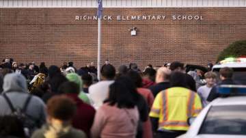 Students and police gather outside of Richneck Elementary School after a shooting.