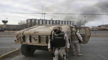 Mexican soldiers stand guard outside a state prison in Ciudad Juarez.