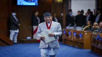 Nepalese Prime Minister Pushpa Kamal Dahal walks to speak before taking the vote of confidence in Nepal's parliament in Kathmandu.