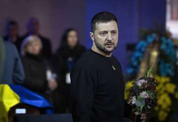 Ukrainian President Volodymyr Zelenskyy  pays his respects to victims of a deadly helicopter crash during a farewell ceremony in Kyiv.