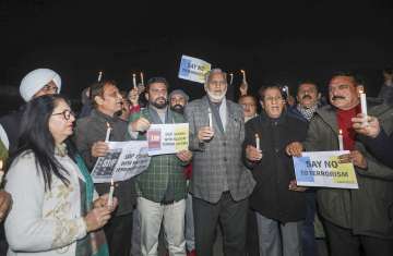 Democratic Azad Party (DAP) leaders and supporters take part in a candlelight vigil to show solidarity with the Rajouri terror attack victims, in Jammu